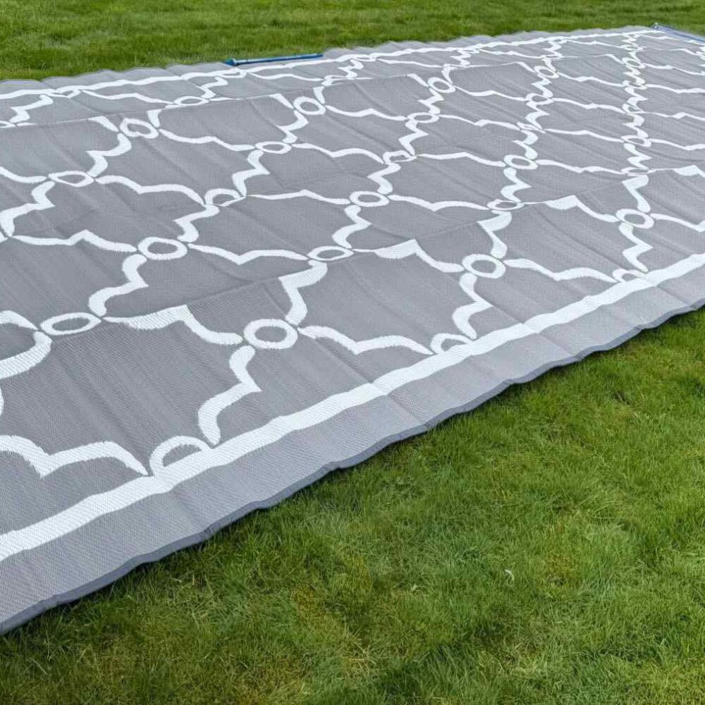 7m x 3m Reversible St Tropez French Awning Mat (Grey/White) laid out on grass showing the stylish lattice pattern